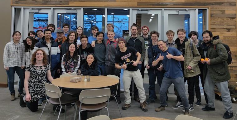 Many people face the camera for a photo.